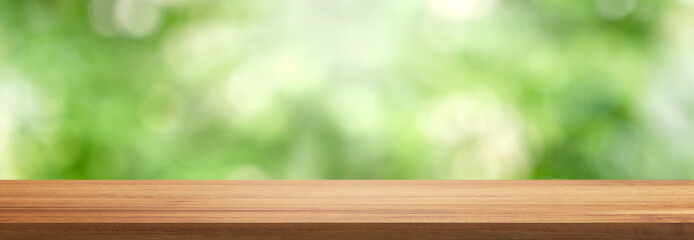 Empty wood table top with bokeh green nature background. Display product for Banner or advertise on social media,spring or summer concept