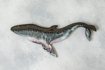 Creative Resin art whale on gray background. Epoxy art. Flat lay