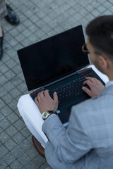 Working on his laptop