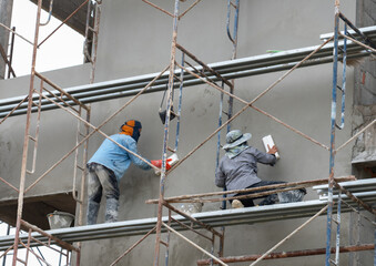 Technicians are plastering the walls to be smooth and beautiful