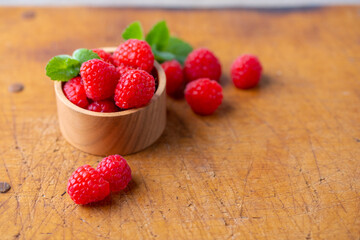 Fresh raspberries on wooden board.
