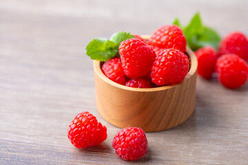 Fresh raspberries on wooden board.
