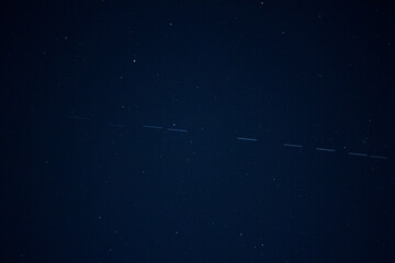 Starlink satellites passing by in the night sky