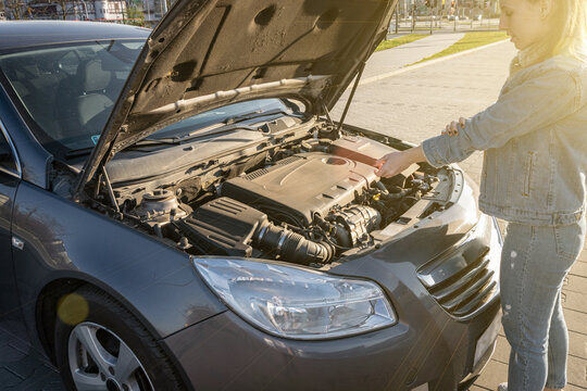 Auto vehicle broken down on road. Driver girl near open hood auto. Motor car problem concept. - Powered by Adobe