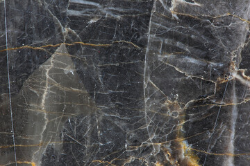 Yellow and white patterned natural detailed structure of dark gray marble (Russia Gold) texture for interior or product design. Abstract background.