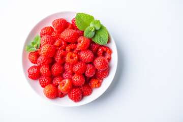 Fresh raspberries in a plate.