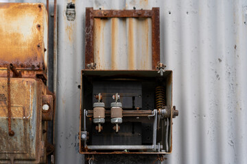 Fototapeta na wymiar old rusty electrical box of side on abandoned warehouse