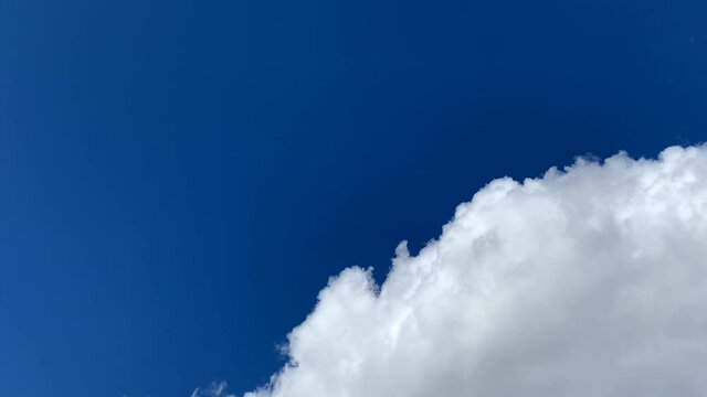 Light white clouds fly across the blue sky. Cloud movement. Background of a spring cloud landscape. Copy space