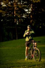 Fototapeta na wymiar Young man riding ebike in the park