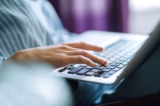 Close up picture of females hands on the keyboard. Young female freelancer working at home using her laptop. Distant work and education online. Working from home in quarantine lockdown.