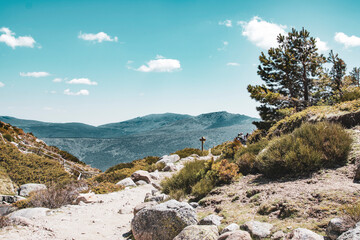 Trail on a mountain with signpost. Extreme long shot.