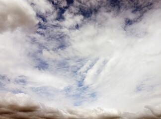 White Clouds on Blue Sky with Darker Rain Clouds on Fringe