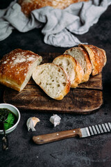 Homemade Ciabatta Bread. Sliced ​​bread slices on a wooden board. Bread with pesto sauce