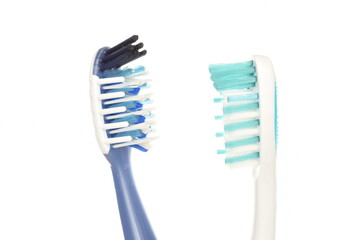 Two toothbrushes, close-up, isolated on white.