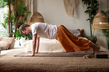 Step of surya namaskar, sun salutation Exercise, plank pose by caucasian man