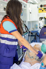 Nurse applying cardiopulmonary resuscitation manoeuvre in an ambulance. Simulation  - obrazy, fototapety, plakaty