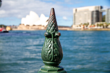 metal railing pole with Sydney Opera house blurred into the background photo taken at Circular Quay...