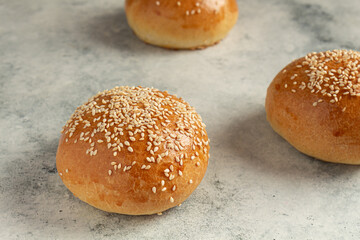 ready-made burger buns on a gray background. Home cooking