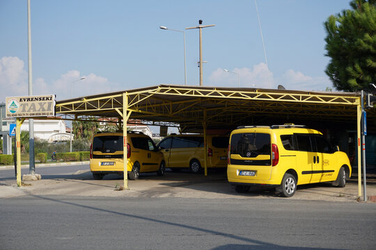 Side / Turkey - October 16 2019: Three yellow taxi cars stand under a hinge from the sun while waiting for customers. Great vacation in Turkey.  