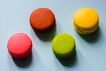 multicolor macaron cakes on a blue paper background