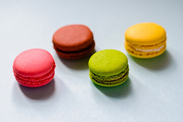 multicolored macaron cakes on a blue paper background
