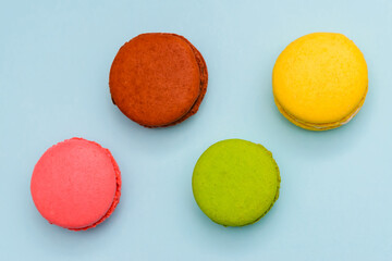 multicolored macaron cakes on a blue paper background