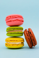 multicolored macaron cakes on a blue paper background