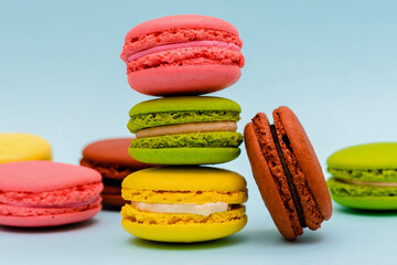 multicolored macaron cakes on a blue paper background