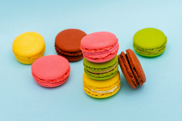 multicolored macaron cakes on a blue paper background