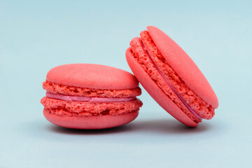 pink macaron cake on a blue paper background