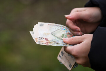 Selective focus on detail of LEI banknotes. Counting or giving Romanian LEI banknotes. World money concept, inflation and economy concept