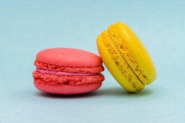 two color macaron cakes on a blue paper background