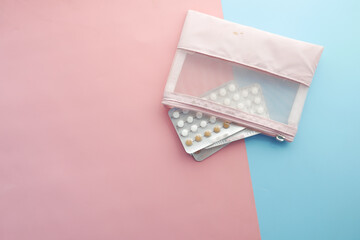 birth control pills on wooden background, close up 
