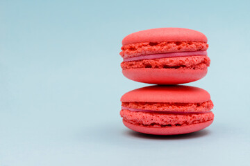 two pink macaron cakes on a blue background