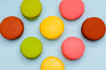 several color macaron cakes on a blue background