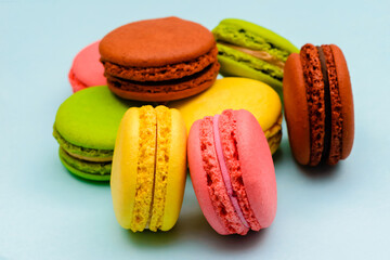 several color macaron cakes on a blue background