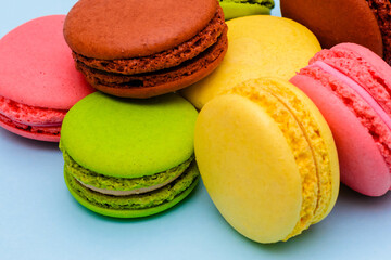 several color macaron cakes on a blue background