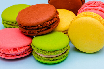 several color macaron cakes on a blue background