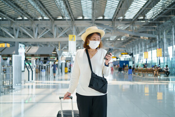 New Normal tourist wearing face mask is traveling on The airport , New lifestyle travel after covid-19. Social distancing healthcare system ,stay safe and Travel bubble concept.