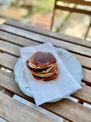 Almond Flour made Paleo Pancakes served with hand in Plate.