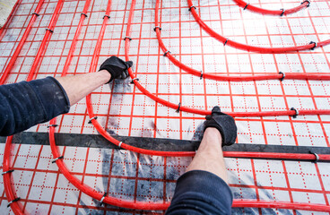 Pipefitter install system of underfloor heating system at home