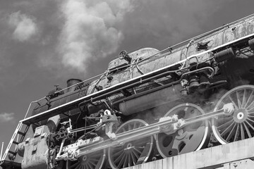 Retro locomotive on the bridge. Old steam train of the USSR era