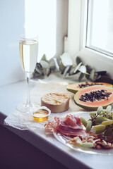 authentic home indoor picnic, champagne glass, papaya, camembert cheese