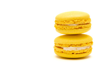 two yellow macaron cakes with copy space on a white background
