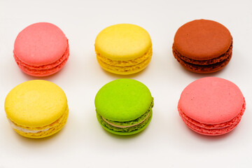 Fototapeta na wymiar six multicolored macaron cakes on a white background