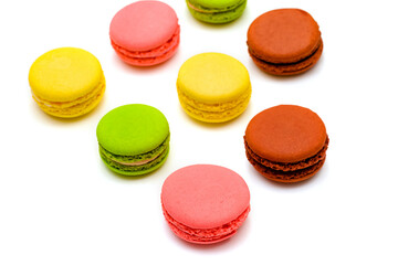 several multicolor macaron cakes on a white background