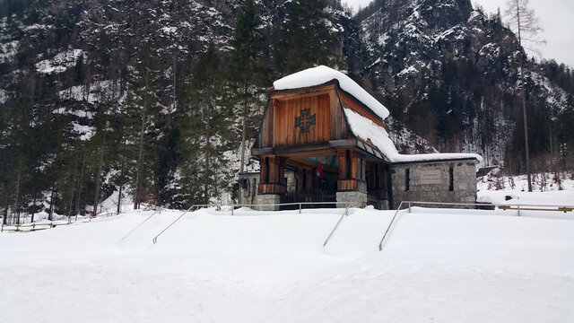 Malborghetto Valbruna, Italy - December 23, 2020: Cimitero degli Eroi (Hero Cemetery). Austro-Hungarian military cemetery of the WWI in Val Saisera. Cloudy winter afternoon with a lot of snow.