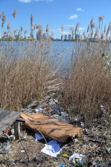 Ecology of Ukraine. Trash near the lake in Ukrainian capital. Environmental contamination. Illegal junk dump.  Kiev