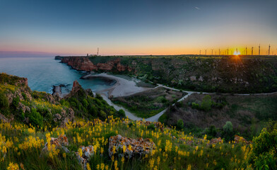 Sunset over the sea and wind power generatiors