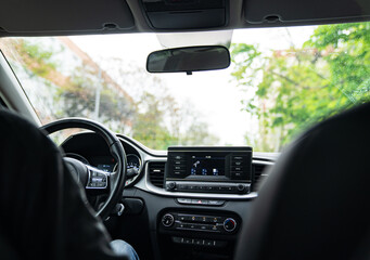 Interior of the car with a multimedia device on the dashboard. 